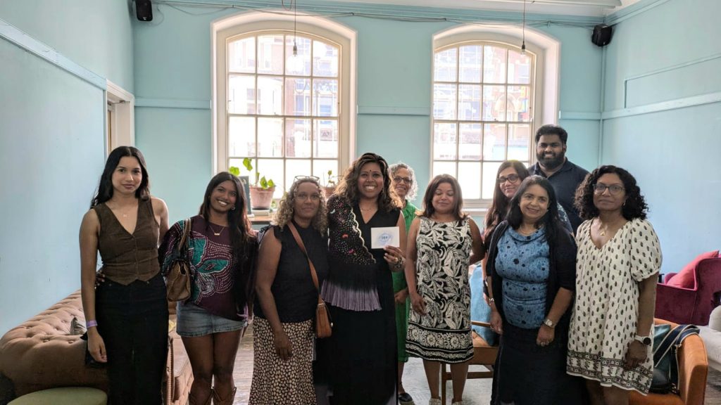 Nisha and a group of smiling workshop participants gathered at the Sri Lankan Culture Collective event.
