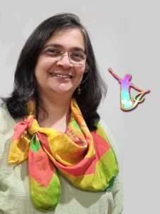 Anu Nadimpalli, smiling, wearing a scarf she designed.